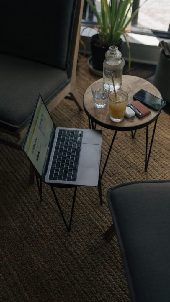 A cozy home setup with a laptop and drinks, representing a calm at-home routine.