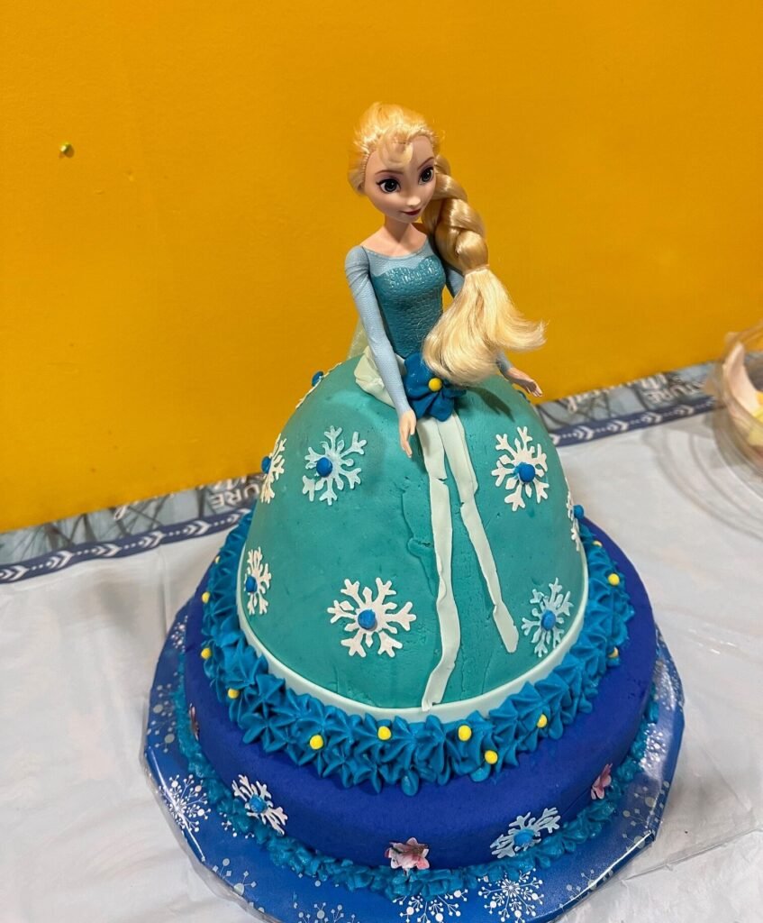 Custom princess doll cake with snowflake details by Honey’s Baking Company